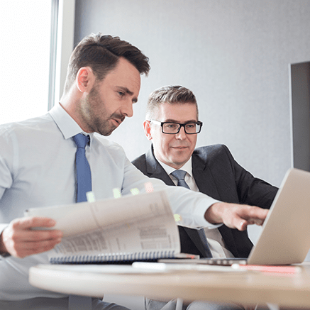 two business men looking over reports