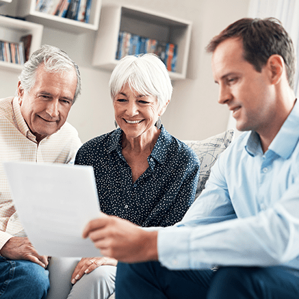 retired couple reviewing insurance policy with broker