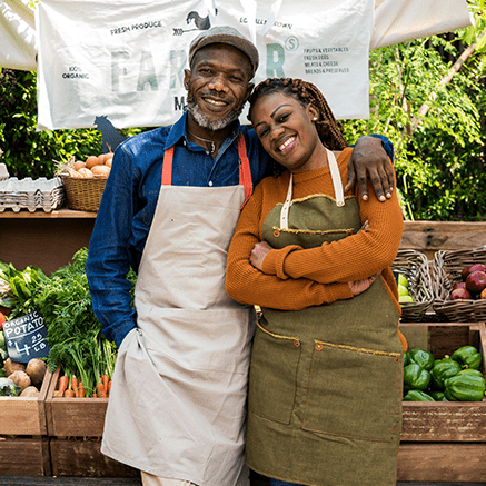 Free with Mobile Banking man and woman standing in front of produce
