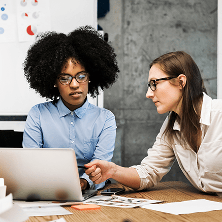 two women looking at laptop