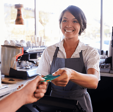Everyday Cash Access woman cashier accepting credit card for payment