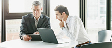 Invest for the Future two business men looking at laptop