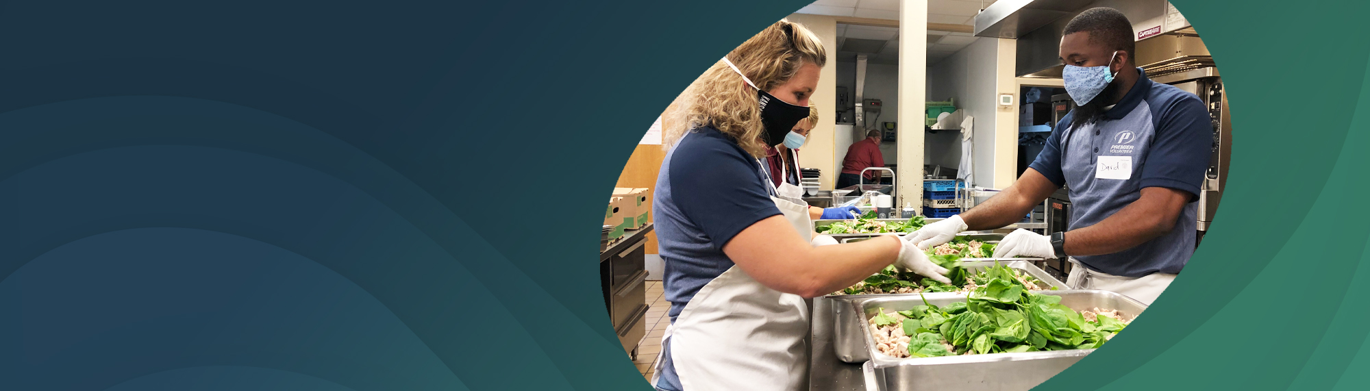 employees serving food at a kitchen