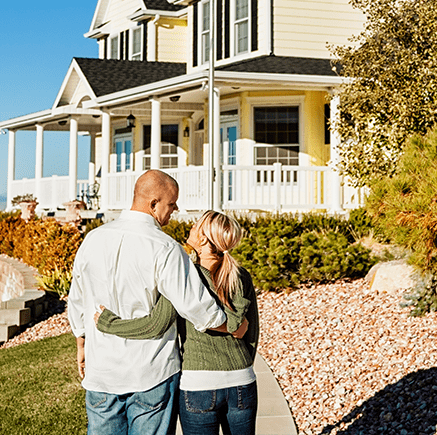 couple standing in front of new home