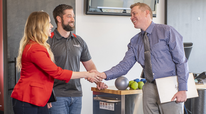 mortgage banker shaking hands with business woman