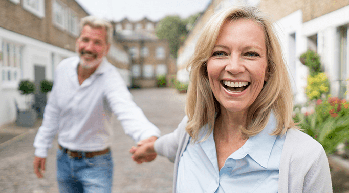 couple holding hands laughing