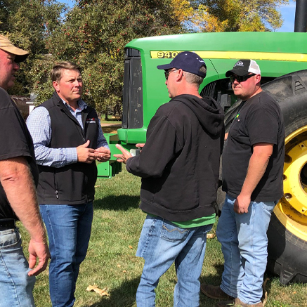 banker talking to two farmers