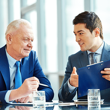 two business men looking over reports