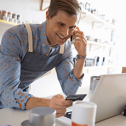 man paying with credit card over phone