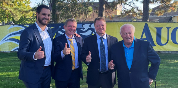 Men in suits giving the thumbs up