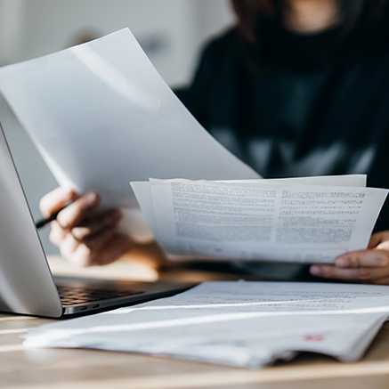 Step 2: Processing & Underwriting person with papers on desk