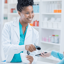pharmacist taking payment by mobile phone 