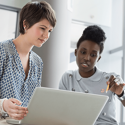 two women looking at laptop